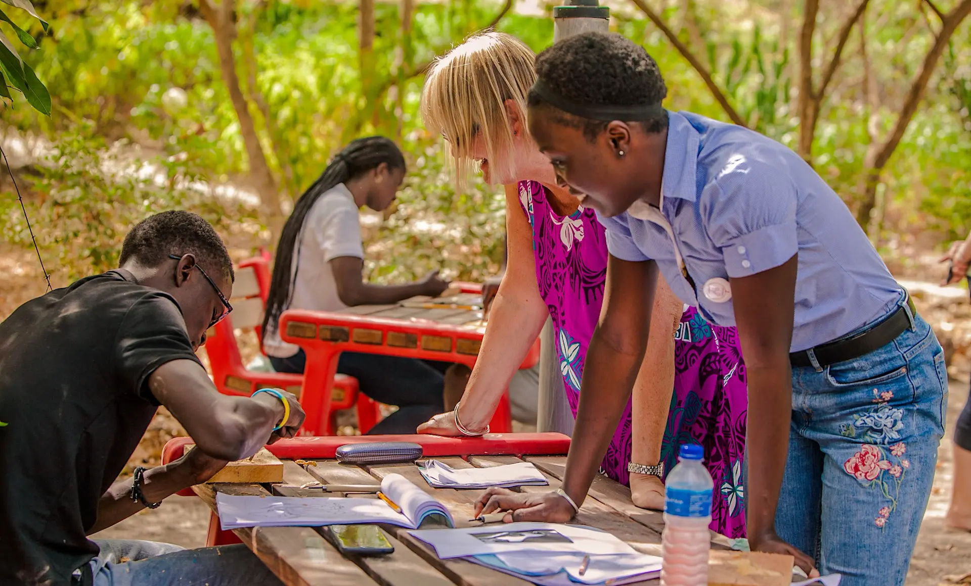 Students in Gambia creating art on cotton